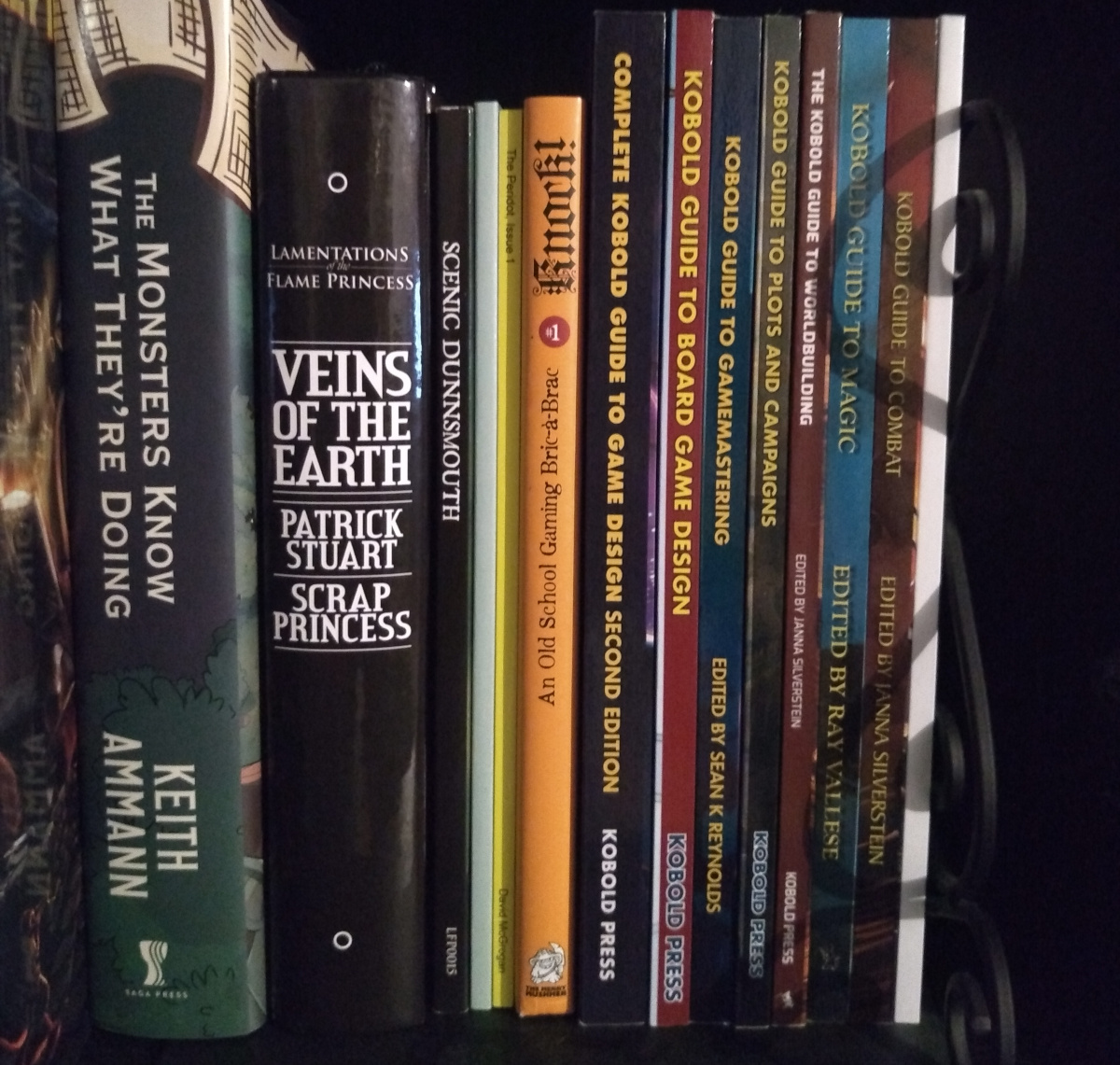 Part of my RPG bookcase, showing the text on the spine of Knock! is oriented differently.